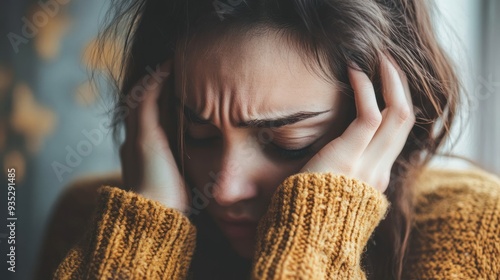 Close-up of a woman with her hands covering her face