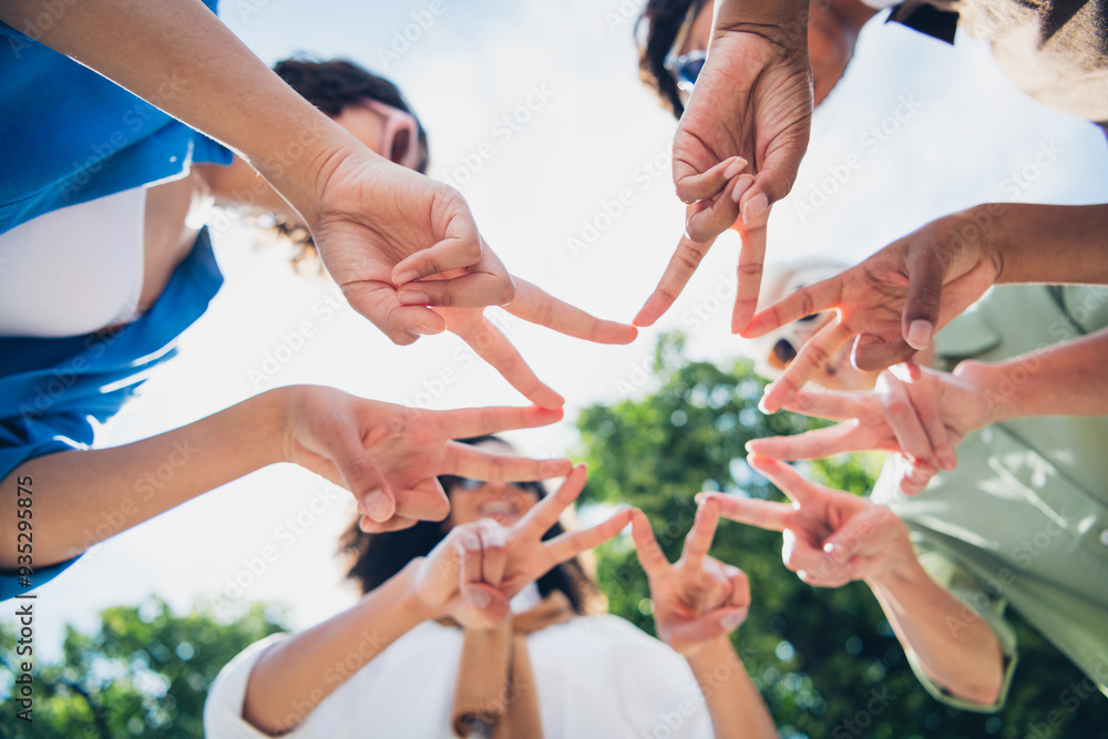 Fototapeta premium Low angle view photo of company friends women show v-sign touch fingers free time chill walk city park outdoors