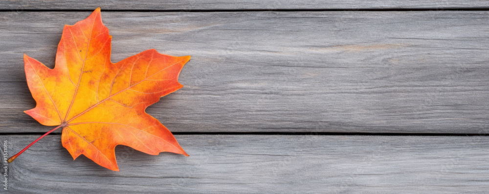 Autumn Leaf on Weathered Wood, a vibrant orange maple leaf rests on textured gray wooden planks, reflecting the beauty of fall and natures cycle of change. Autumn Leaf on Weathered Wood, a vibrant orange maple leaf rests on textured gray wooden planks, reflecting the beauty of fall and natures cycle of change.