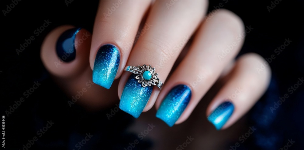 Close-up of a Female Hand with Blue Ombre Nail Polish and a Turquoise Ring. Close-up of a Female Hand with Blue Ombre Nail Polish and a Turquoise Ring.