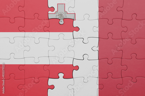 puzzle with the colourful national flag of malta and flag of austria. photo