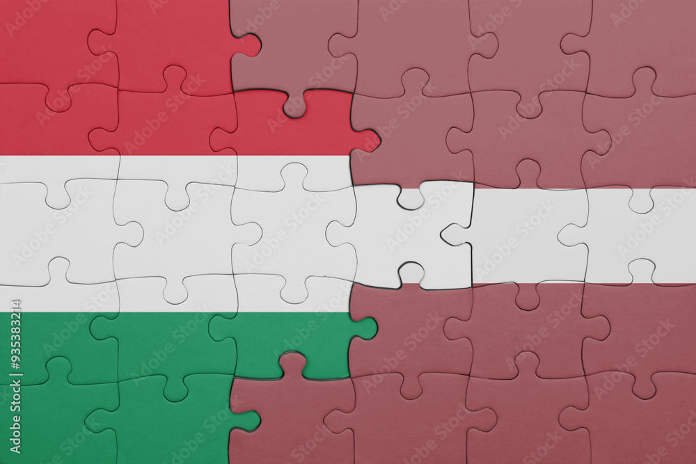 puzzle with the colourful national flag of latvia and flag of hungary. puzzle with the colourful national flag of latvia and flag of hungary.