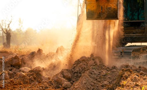 Backhoe working by digging soil at construction site. Crawler excavator digging on demolition site. Excavating machine. Earth moving machine. Excavation vehicle. Construction business.