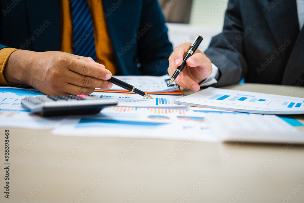 close-up of two professionals' hands meeting at a desk, discussing business strategies over a digital tablet and laptop. teamwork, planning, and communication in a corporate office setting. close-up of two professionals' hands meeting at a desk, discussing business strategies over a digital tablet and laptop. teamwork, planning, and communication in a corporate office setting.