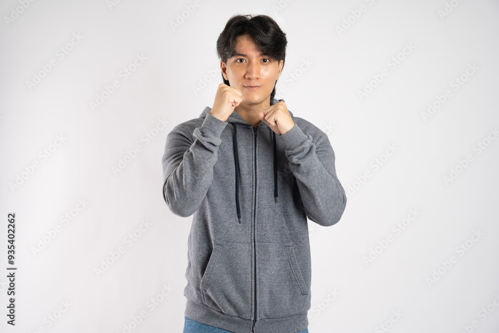 Portrait of asian man wearing hoodie posing on white background Portrait of asian man wearing hoodie posing on white background