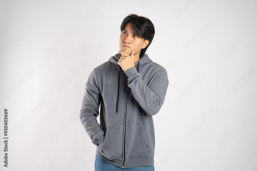 Portrait of asian man wearing hoodie posing on white background Portrait of asian man wearing hoodie posing on white background