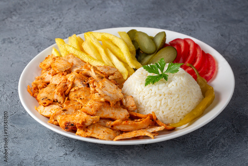 Obraz na płótnie Chicken doner on pilaf with french fries and pickles w salonie
