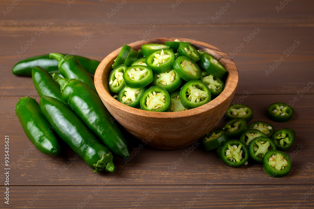 Fresh green jalapeno peppers on wooden table
