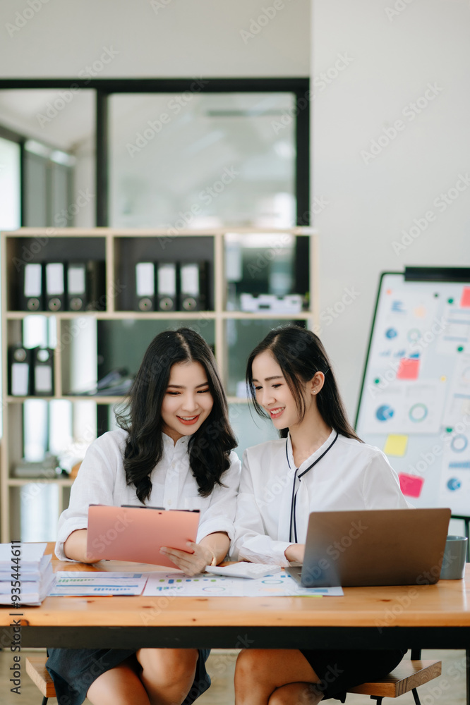 Two Asian businesswoman and man discuss investment project working and planning strategy Two Asian businesswoman and man discuss investment project working and planning strategy