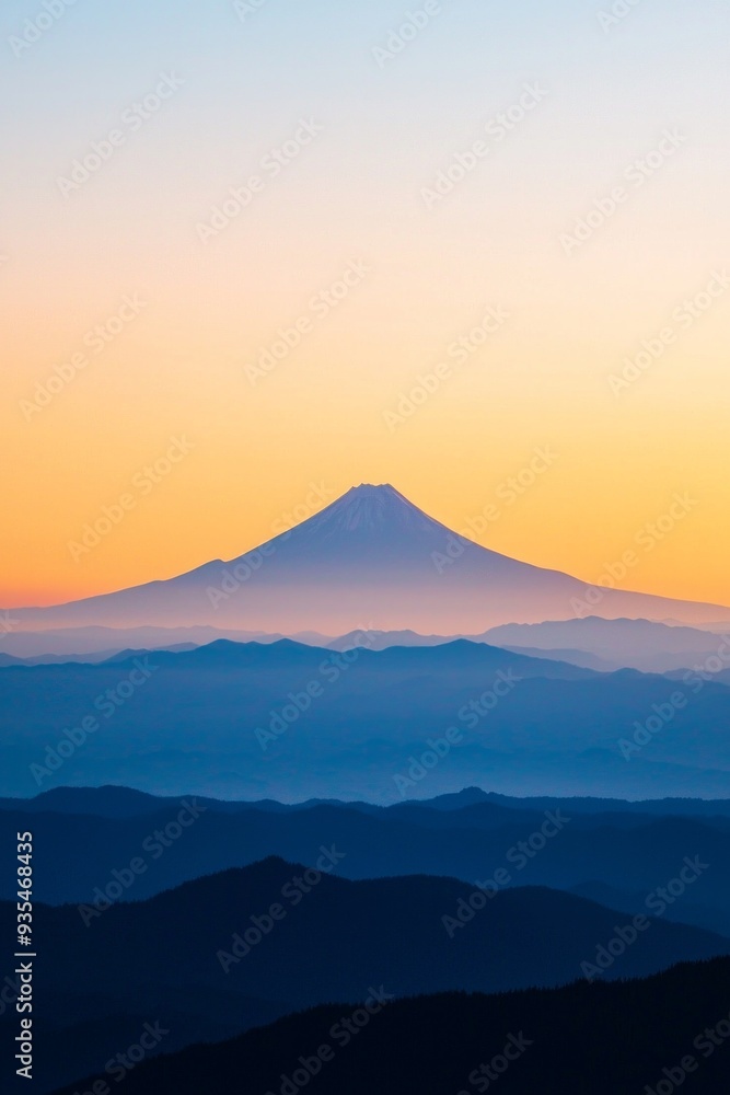 The peak of a distant mountain framed against a sunset sky The peak of a distant mountain framed against a sunset sky