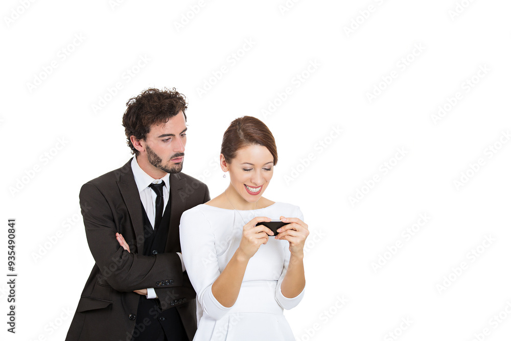 A young man looks over his girlfriend's shoulder, trying to find out who she is writing to. A young man looks over his girlfriend's shoulder, trying to find out who she is writing to.