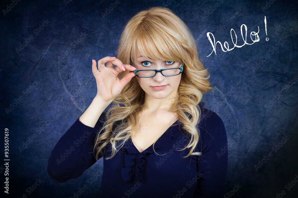 Portrait of a cute woman looks over glasses at camera Portrait of a cute woman looks over glasses at camera