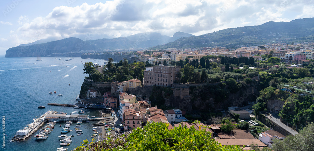 Panoramic drone shot of Sorrento town in Italy against dramatic clouds, cityscape of Italian town port harbor in south