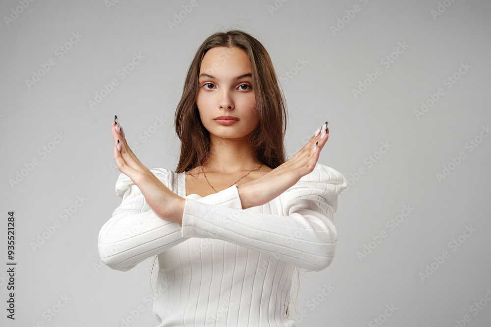 Young Woman Making a Stop Gesture With Crossed Arms Young Woman Making a Stop Gesture With Crossed Arms