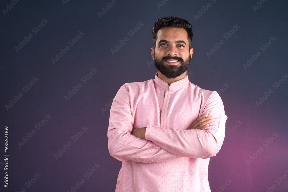 Portrait of a happy young man posing with arms crossed or hands folded on a dark background Portrait of a happy young man posing with arms crossed or hands folded on a dark background