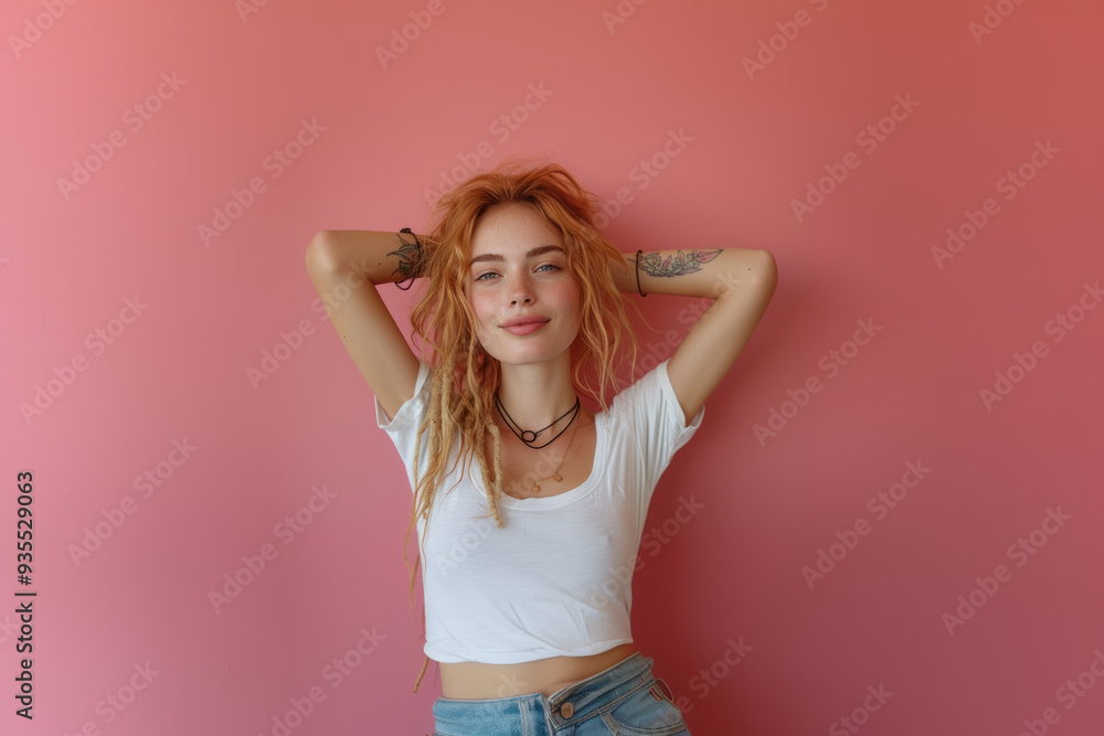 Cheerful red-haired woman with tattoos posing against rustic background Cheerful red-haired woman with tattoos posing against rustic background