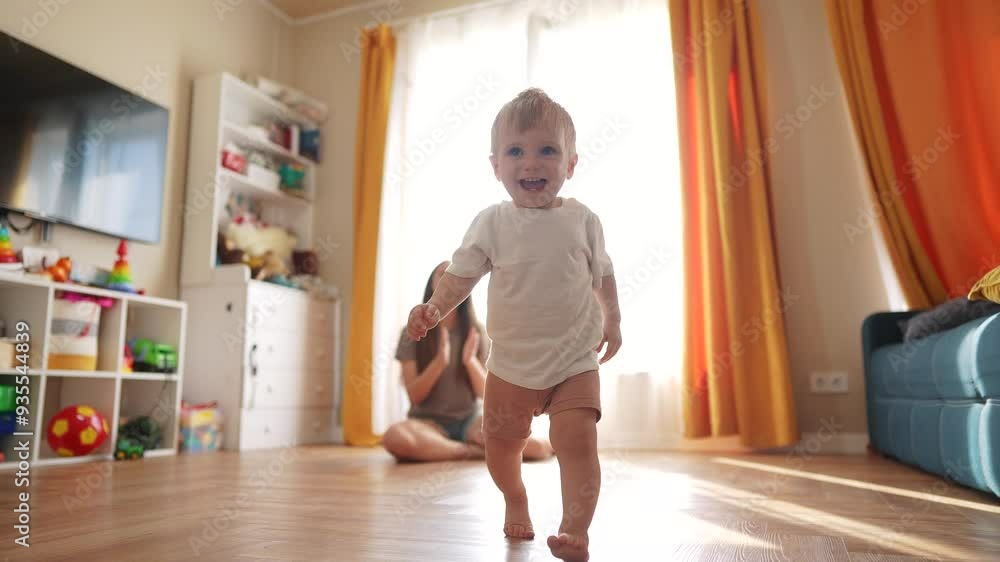 The first steps baby of learning to walk in home. Child toddler family concept. A baby is taking the first steps on its legs. A baby takes the first steps lifestyle on his legs at home. The first steps baby of learning to walk in home. Child toddler family concept. A baby is taking the first steps on its legs. A baby takes the first steps lifestyle on his legs at home.