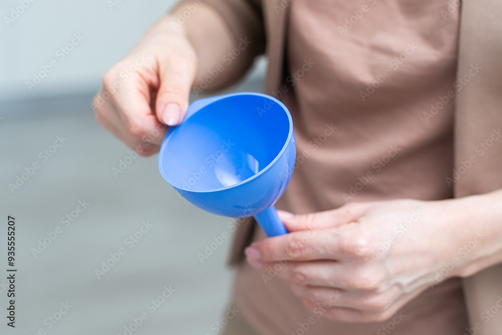 hand holds a funnel isolated on white background hand holds a funnel isolated on white background