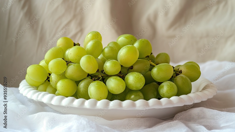 Green grapes on white platter, fresh and healthy fruit, simple and elegant presentation Green grapes on white platter, fresh and healthy fruit, simple and elegant presentation