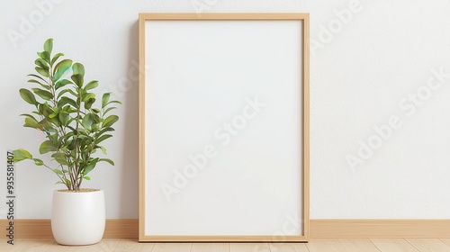 Wooden Frame Display on Floor, Vertical wooden frame poster resting on a wooden floor against a white wall, showcasing a blank canvas for creative design possibilities.