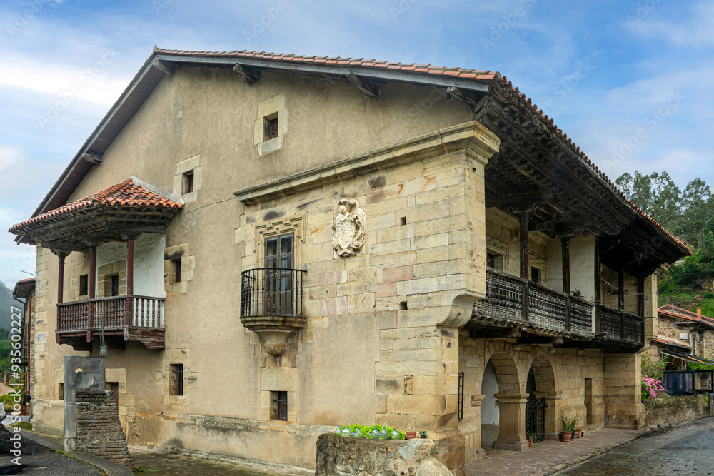 Typical pasiega house from Cantabria, Spain, in the town of Barcenillas with heraldic shield and wooden balconies Typical pasiega house from Cantabria, Spain, in the town of Barcenillas with heraldic shield and wooden balconies
