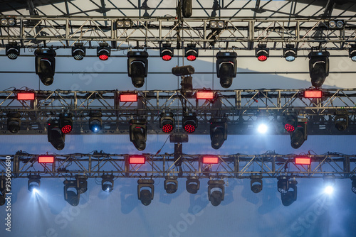 Design of spotlights hanging from rigging on the ceiling of the stage at a music festival