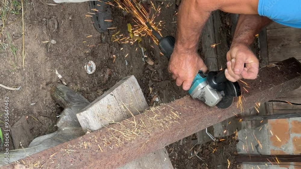 A man is cutting a metal corner with a angle grinder. Vertical video A man is cutting a metal corner with a angle grinder. Vertical video