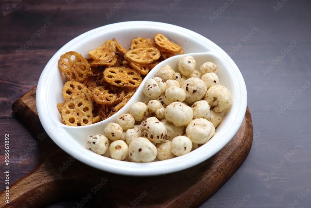 Crispy lotus stem chips and roasted makhana, perfectly spiced and golden brown, offer a delightful crunch and unique flavor. Ideal for healthy snacking or as a gourmet appetizer. kurkuri Kamal kakdi. Crispy lotus stem chips and roasted makhana, perfectly spiced and golden brown, offer a delightful crunch and unique flavor. Ideal for healthy snacking or as a gourmet appetizer. kurkuri Kamal kakdi.