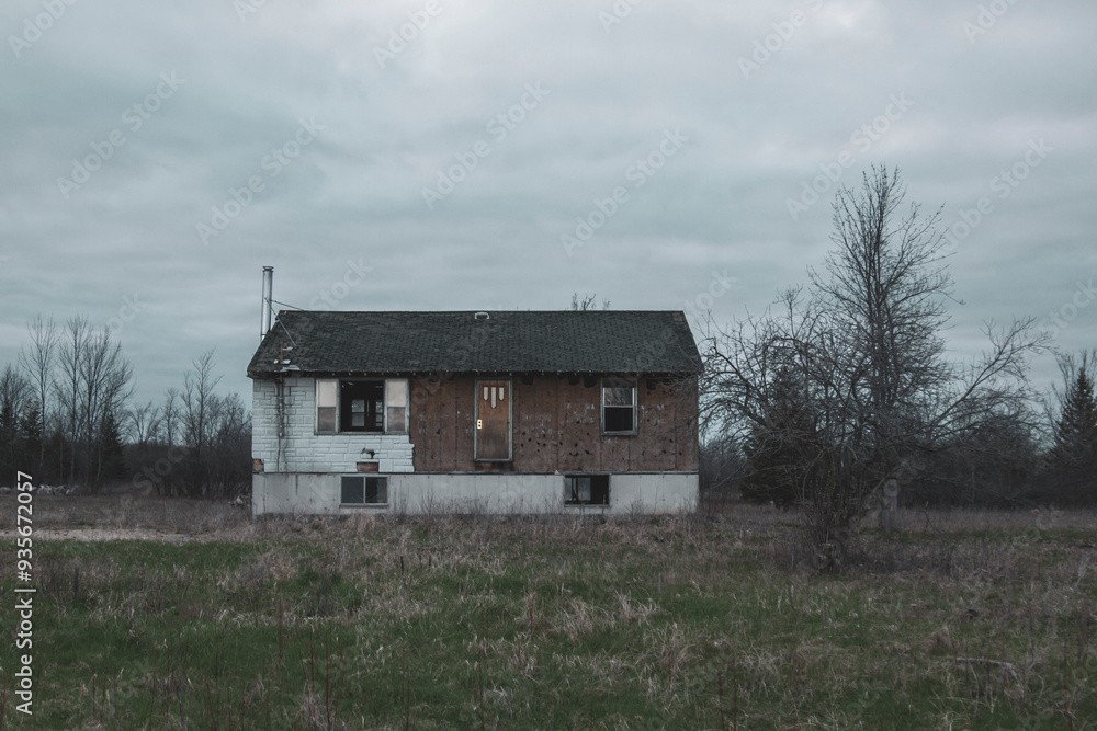 Abandoned, rundown decrepit house in an empty field. Abandoned, rundown decrepit house in an empty field.