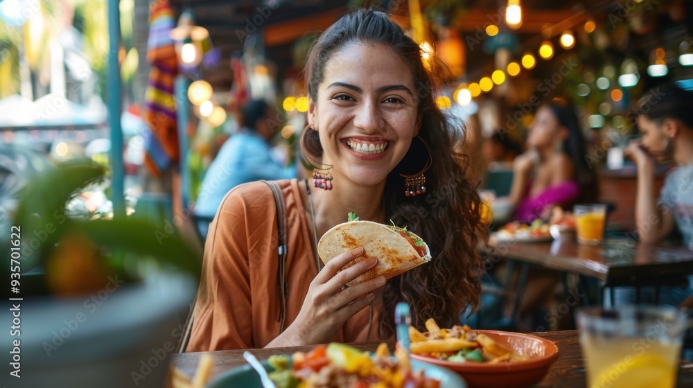 Young woman smiling while enjoying delicious tacos at a restaurant patio table outdoors. Young woman smiling while enjoying delicious tacos at a restaurant patio table outdoors.