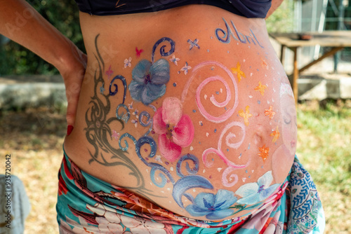 Beautiful painting of multi-colored pregnant mother belly