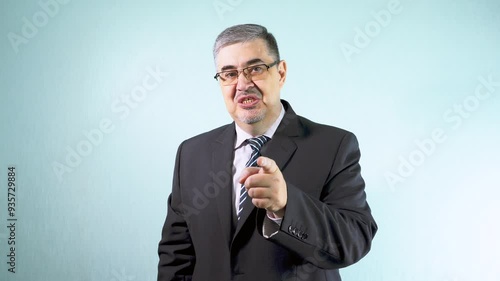 A man in a suit and glasses scolds a subordinate with disdain for poor performance. Concept of workplace conflict, management, and leadership. photo