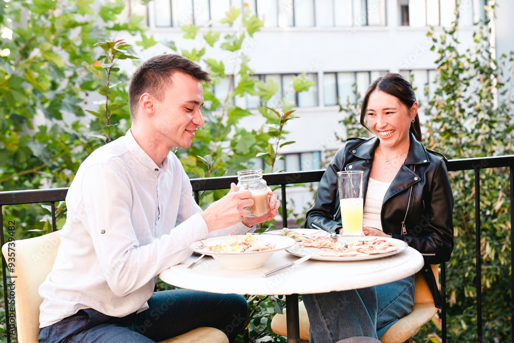 Happy young couple having lunch at outdoors restaurant Happy young couple having lunch at outdoors restaurant