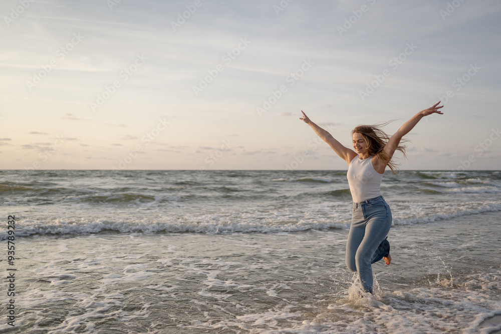 Beautiful young woman enjoying warm summer wind and walk on the sea Beautiful young woman enjoying warm summer wind and walk on the sea