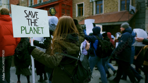 Save planet ecology protest outdoor. Activist person hold anti global warming banner. Eco demonstration placard. No climate change concept. City street picket background. World care rally Earth poster photo