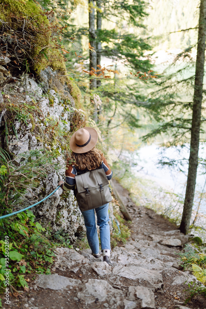 Cheerful woman exploring a lush green forest wearing a stylish sweater and hat on a sunny day Cheerful woman exploring a lush green forest wearing a stylish sweater and hat on a sunny day