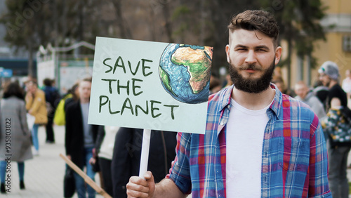 Save planet ecology protest outdoor. Activist person hold anti global warming banner. Eco demonstration placard. No climate change concept. City street picket background. World care rally Earth poster photo