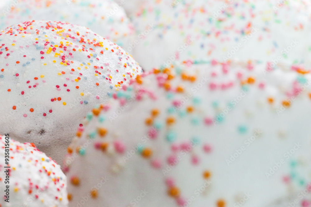 Flour pastries with white icing and colorful balls Flour pastries with white icing and colorful balls