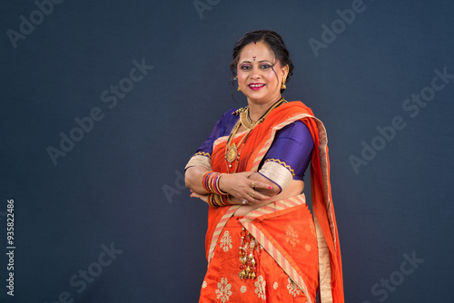 Portrait of traditional Indian woman wearing saree posing with hands fold