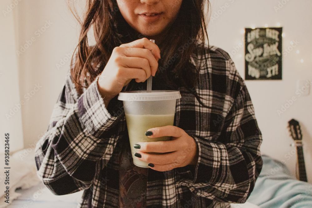 girl drinking drink from glass with straw closeup girl drinking drink from glass with straw closeup