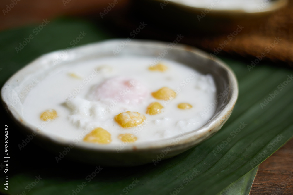 Thai glutinous rice balls with coconut milk on wood Thai glutinous rice balls with coconut milk on wood