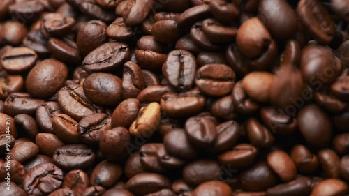 Close up of pouring whole coffee beans background, dark roasted espresso coffea arabica