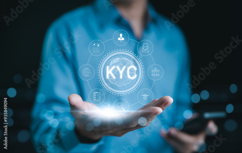 KYC verification concept. Businessman hold glowing digital representation of KYC (Know Your Customer) with compliance and security icons, symbolizing customer identity verification in business. E KYC, photo