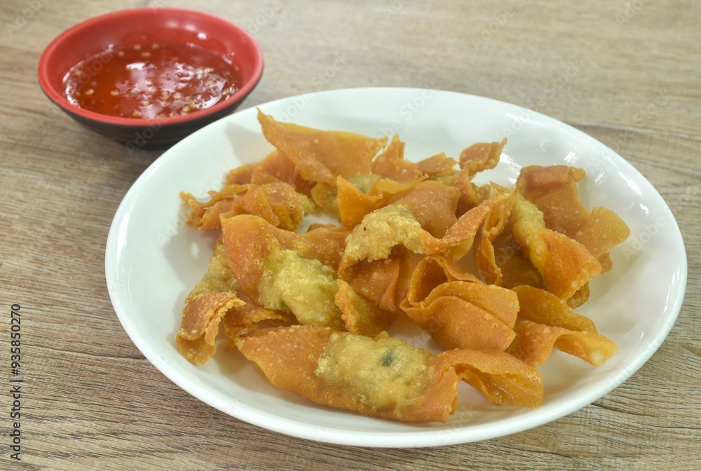 crispy fried dumpling paste stuffed chop pork dipping sweet chili sauce on plate crispy fried dumpling paste stuffed chop pork dipping sweet chili sauce on plate