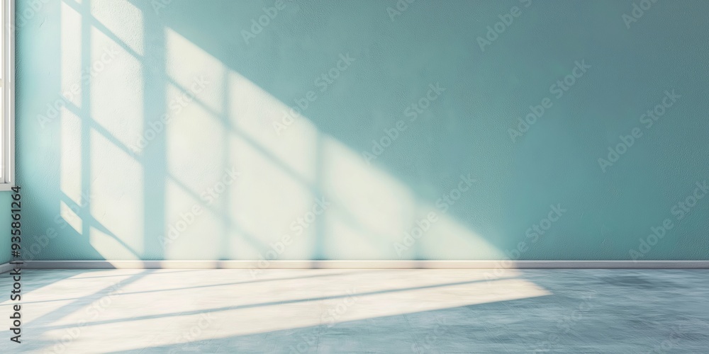 Obraz premium An empty room with tall windows casting sunlight on the floor, highlighting the minimalistic and bright atmosphere of the space.
