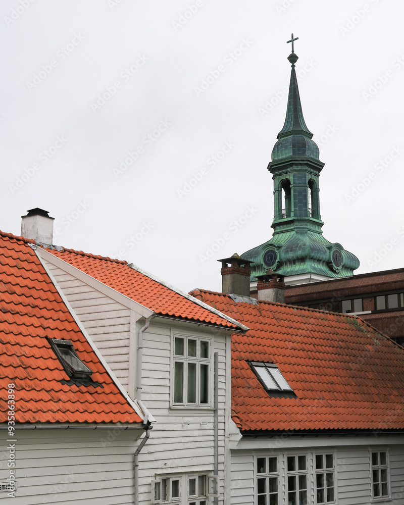 Tower of the Nykirken and tiled roofs in Bergen, Norway. Tower of the Nykirken and tiled roofs in Bergen, Norway.