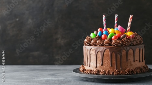 Delicious Chocolate Cake with Colorful Candies for Birthday Celebration - A decadent chocolate cake topped with colorful candies, chocolate frosting and drizzled with chocolate, perfect for any birthd photo