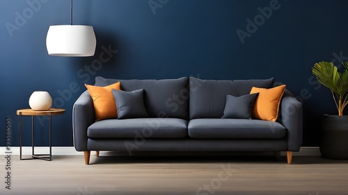 Couch in a comfortable modern living room against a blank, dark blue wall.