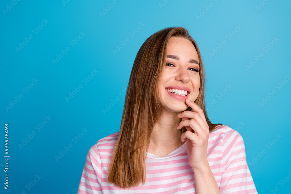 Photo portrait of pretty young girl dance charming smile sweet wear trendy pink striped outfit isolated on blue color background Photo portrait of pretty young girl dance charming smile sweet wear trendy pink striped outfit isolated on blue color background