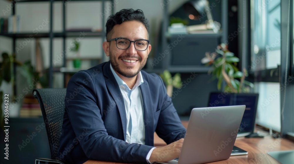 Happy professional businessman company employee Working on technology, laptop computer, looking at camera, working in office, sitting at table Happy professional businessman company employee Working on technology, laptop computer, looking at camera, working in office, sitting at table